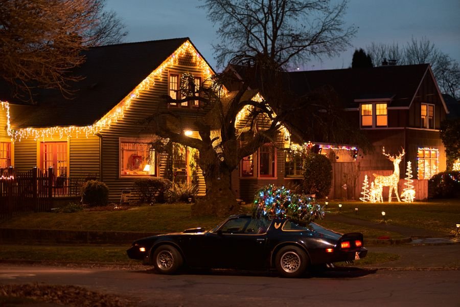 Home roofline outlined in warm Christmas lights